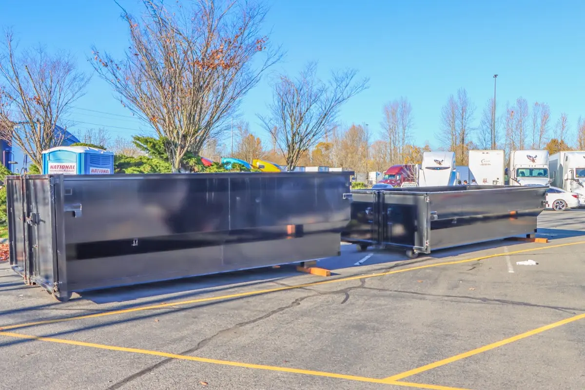 Professional dumpster rental service with roll-off container on residential driveway in Belen